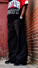 Load image into Gallery viewer, &quot;BAGGY DADDY DIAMOND NYLONS&quot; WIDELEG NYLON PANTS (BLACK W/ METAL PATCH)